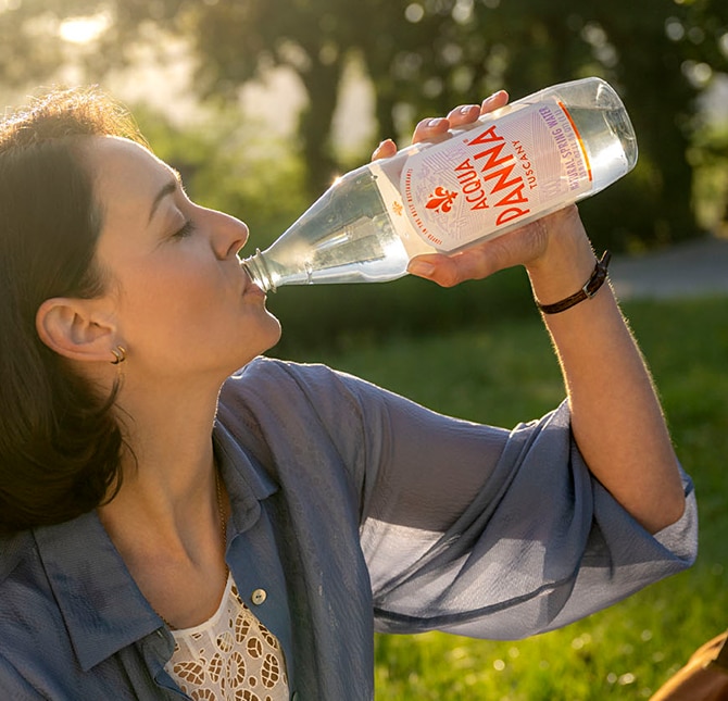 girl drinks acqua panna 1 liter pet bottle
